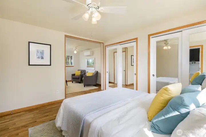 View towards dressing/sitting area & 2 custom closet areas w/ organizer shelves inside