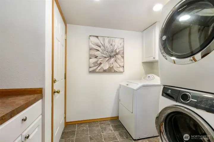 Large laundry room off garage allows for speedy chore completion. 2 full sized washer/dryers in home.
