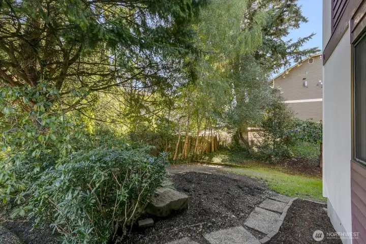 view of walk right outside your door to private side yard.