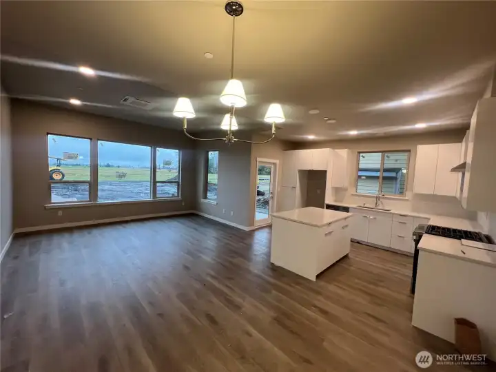 Kitchen with great room concept. Large windows & door leading to backyard.