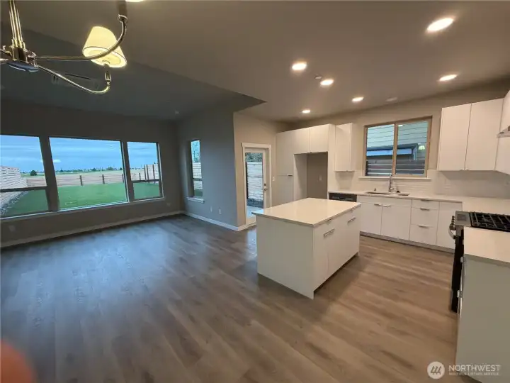 Kitchen with great room concept. Large windows & door leading to backyard.