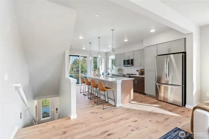Luxury laminate flooring throughout the main level is standard.   Photo is of community model home and same plan.