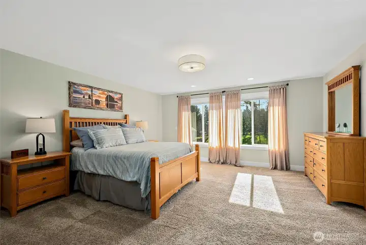 Large primary bedroom with tons of natural light, HIS AND HERS closets and a big bright primary en suite bath.