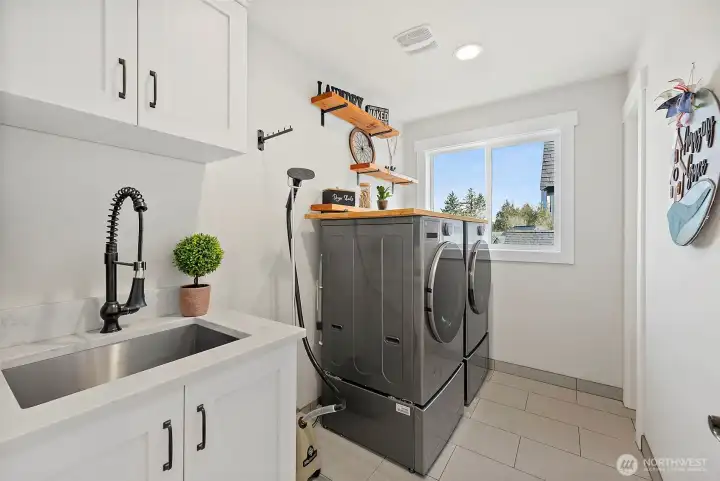 New washer and dryer and storage in this roomy upstairs laundry.