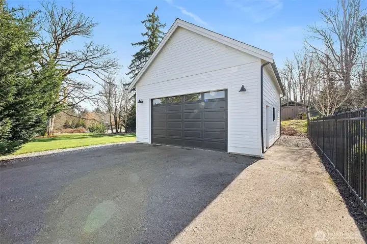 This large detached garage tucked privately in the back of the lot is a half court insulated basketball space. It has also been extra car garage, indoor sport court etc etc. So many options for you. Tucked behing is yet even more storage space. Make sure you walk all the way around!