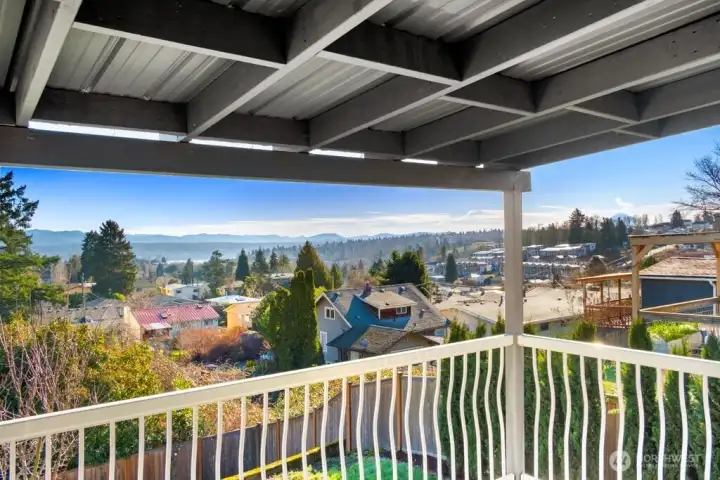 Experience incredible views with this covered Trex-style deck built for outdoor living and grilling