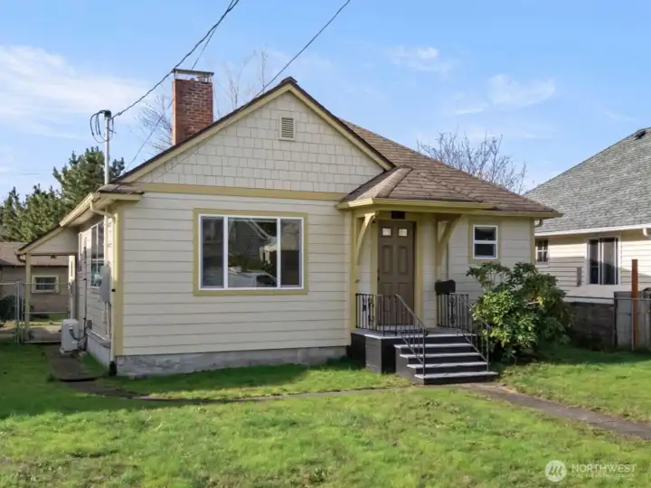 What a cutie! A cheerful soft yellow exterior, classic Craftsman details, and newer cement board siding come together to create a welcoming and refreshed first impression. Welcome Home!