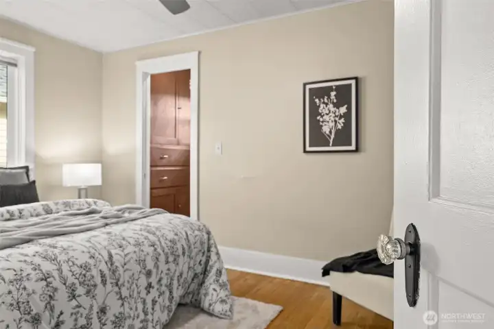 First, take in the gleaming crystal doorknob, one of those charming details you’ll notice throughout the home. And then… wait, is that really a walk-in closet? Yes it is, complete with built-in drawers and cabinetry that feel both thoughtful and delightfully unexpected.