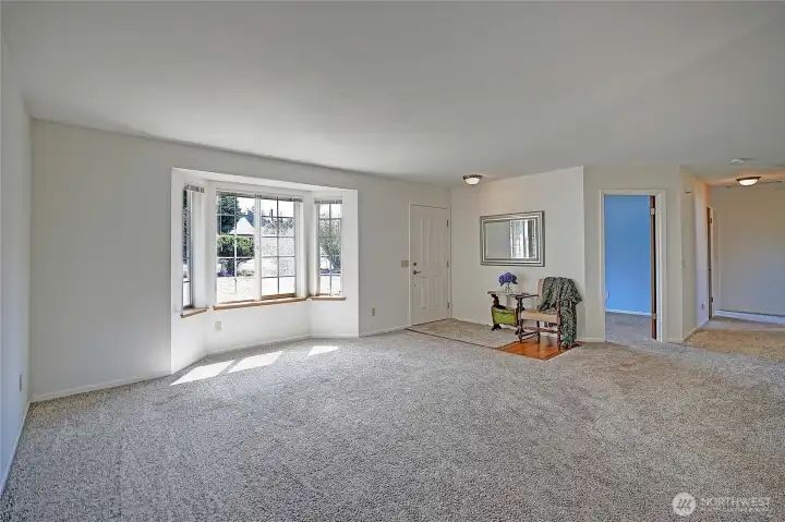 Great living room by the front door with newer carpet and lots of light.