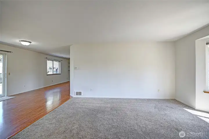 Living room opens up to additional great room spaces.