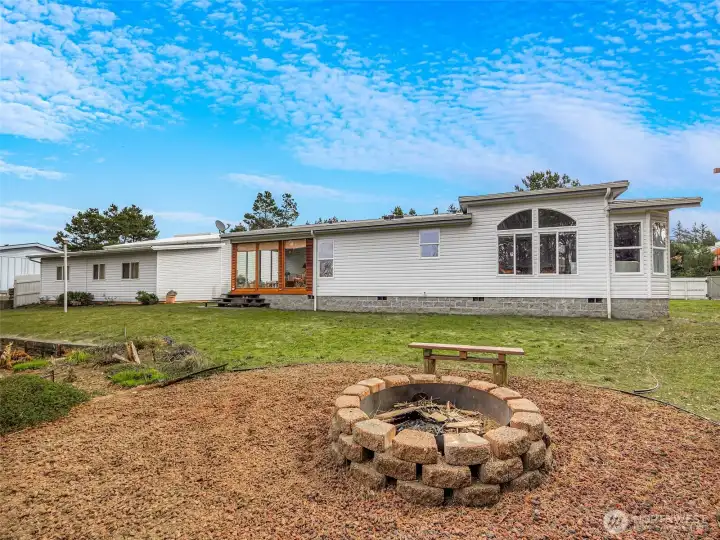 The backyard overlooks the lagoon, firepit, fish cleaning station, dock and more! Great location right outside of Surfside.