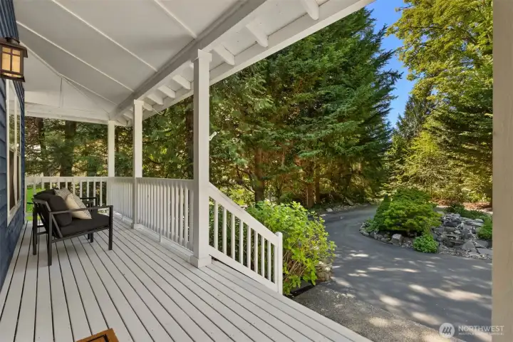 The covered front porch has an excellent view of the centerpiece fountain and mature plantings including an abundance of hydrangeas - a pretty view to come home to. The covered front porch has an excellent view of the centerpiece fountain and mature plantings including an abundance of hydrangeas - a pretty view to come home to.