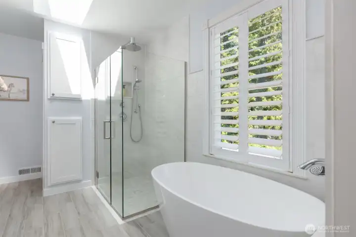 The soaking tub in the modern primary bathroom. The soaking tub in the modern primary bathroom.