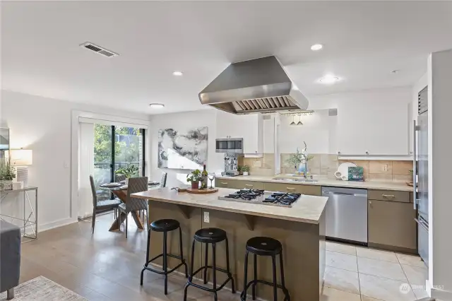 Wolf range hood & travertine counters