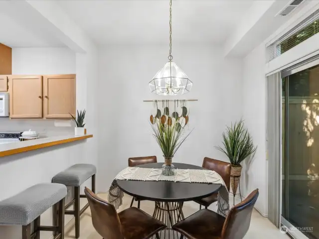 Dining area open to kitchen, with slider to private back yard.