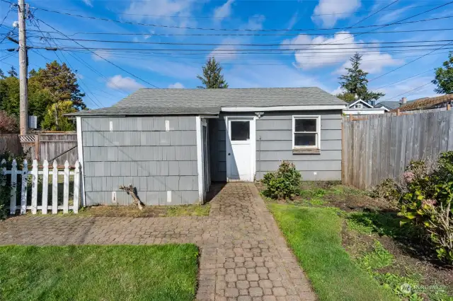 Detached one car garage backs to alley access.