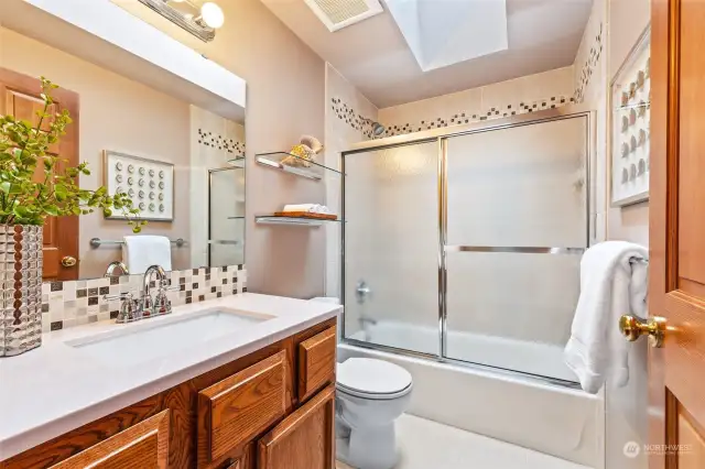 Remodeled upper-level main hall bath with skylight