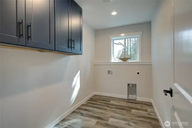 Large utility room with cabinets for extra storage