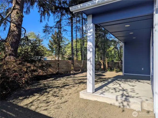 Spacious, fully fenced yard with mature trees
