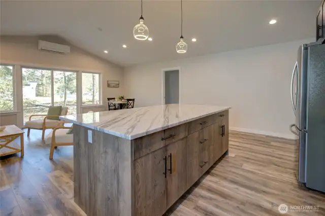 Gorgeous island with cabinets on both sides offers plenty of storage!