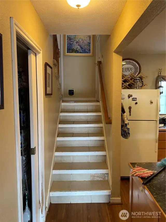 The downstairs 1/2 bath is to the left in this photo, the kitchen to the right and upstairs on that landing is the entry to the attached 1 car garage.