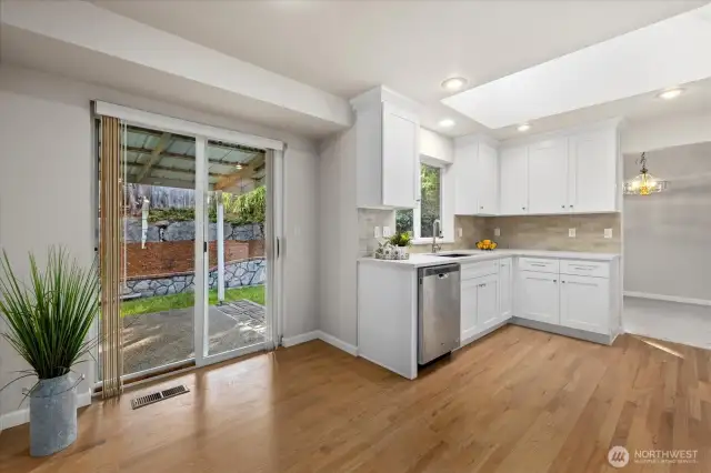 kitchen with skylight opens to the back patio & fully fenced backyard for entertaining!