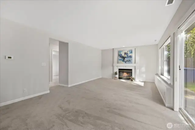 Spacious family room w/wood fireplace.