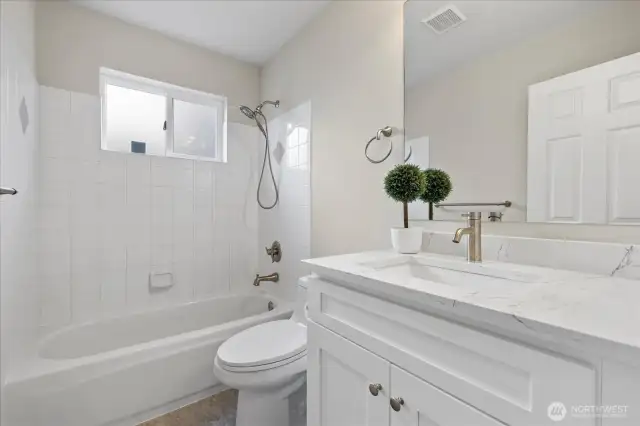 New bathroom vanity cabinets with new floors and toilet on the lower level.