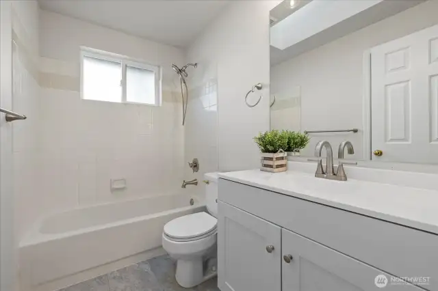 New bathroom vanity cabinets with new floors on the upper level.