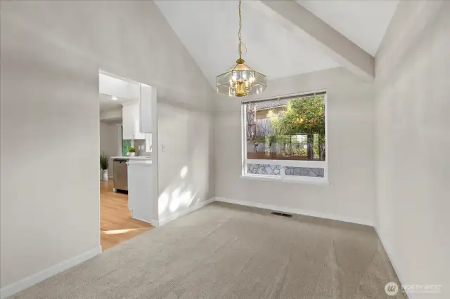 Vaulted ceilings & large windows fill the space w/natural light in dining area.