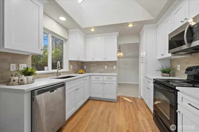 New kitchen cabinets, countertop, hardwood floors.
