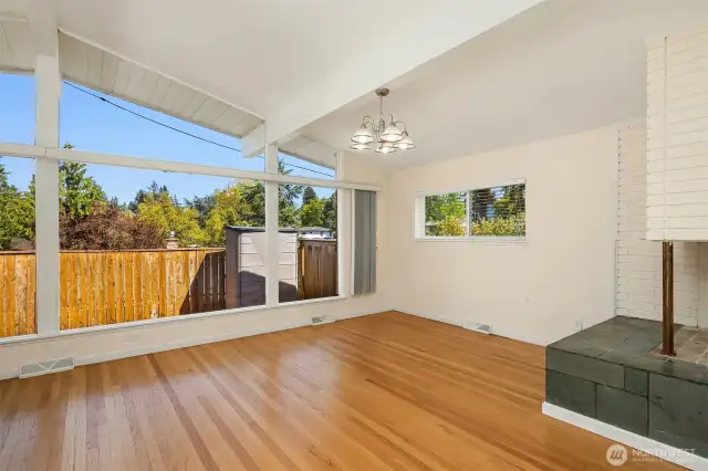A second wood-burning fireplace graces the second living room space.