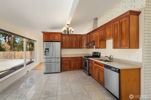 The airy kitchen has plenty of room for a casual dining table.