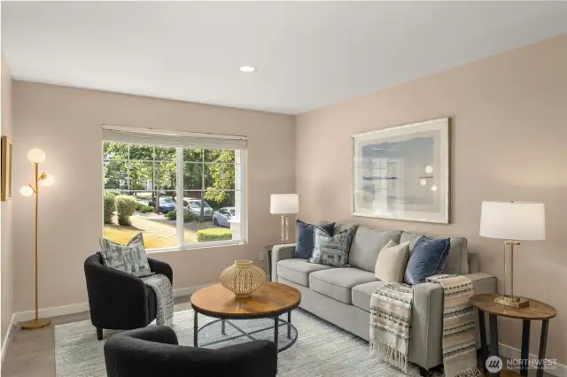 Formal living and dining area with engineered hardwood and neutral interior paint.
