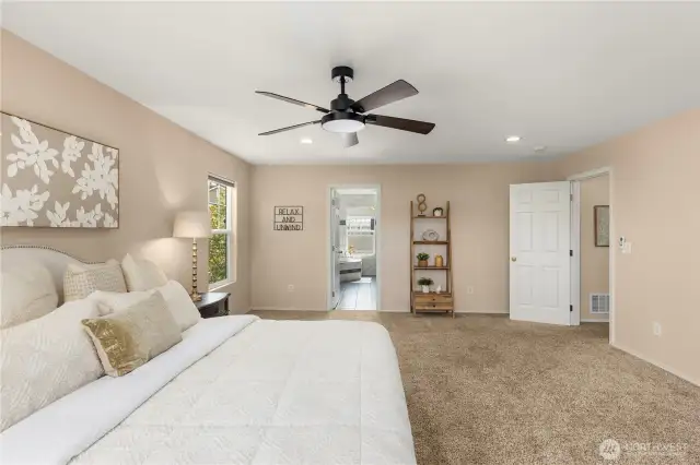 Master bedroom with ensuite bathroom with a tiled standing shower, jacuzzi tub, extra cabinetry and generously sized master closet