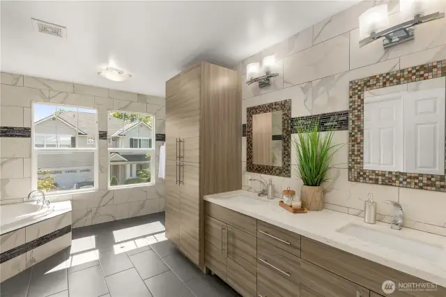 Master bathroom with a tiled standing shower, jacuzzi tub, extra cabinetry, wall to wall tiles