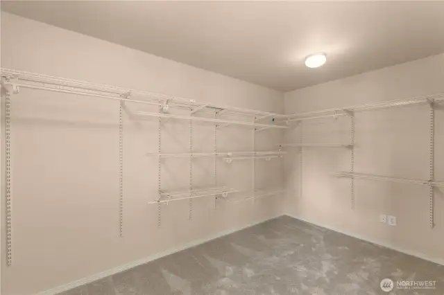 Generously sized master closet with shelves