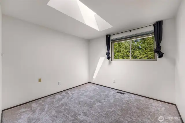 bedroom 2 with natural light from the skylight