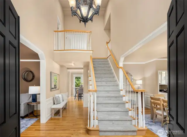Bold double doors welcome you.  With formal living room on left and dining on right, stairs leading up.  Tall ceilings all throughout add volume and warmth.