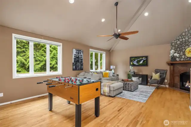 Bonus room features a gas fireplace with river rock and an elegant mantle. Vaulted ceilings, with ceiling fan, and a back staircase leads to the upstairs.  This room could be a movie room, a game room, a study, an office, a guest room - pretty much anything you can imagine, it can accomodate.