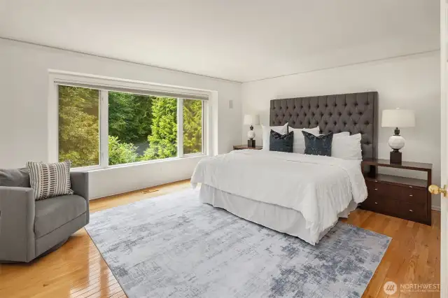 Upstairs, a large primary retreat, with hardwoods and huge windows to take in the backyard views.