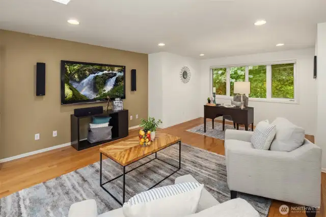 A skylight, a large window, and plenty of canned lights keep the room bright and cozy during any day or season!