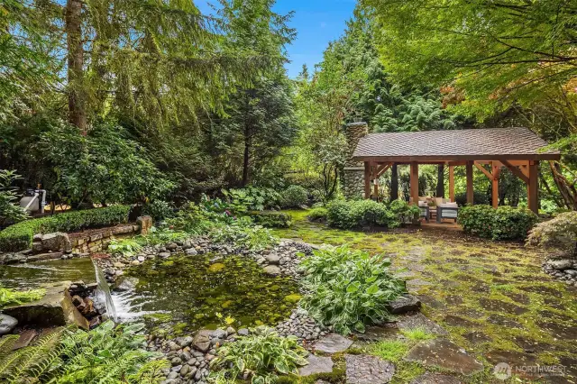 Flag stone grounds surround the water fountain; makes for the most peaceful setting you've ever experienced!  And at dusk, the landscaping is aglow in outdoor lighting, it's stunning.