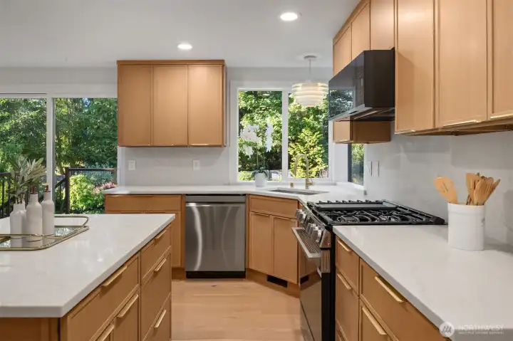 Masterful kitchen renovation with gorgeous quartz countertops as well as full height quartz backsplash.