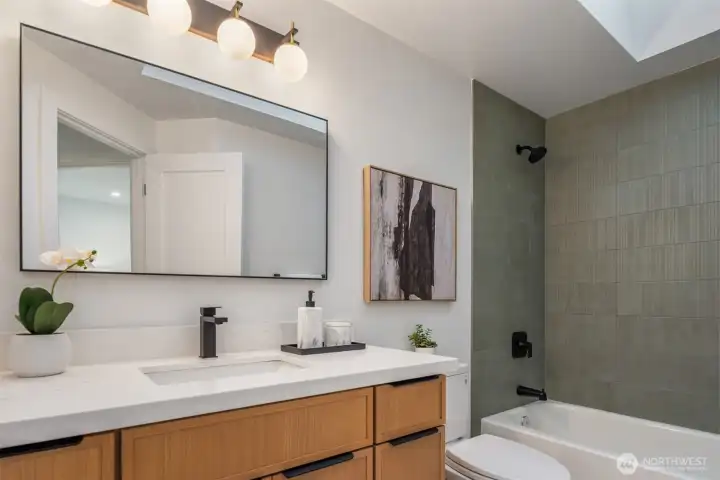 Designer guest bathroom with full height tile.