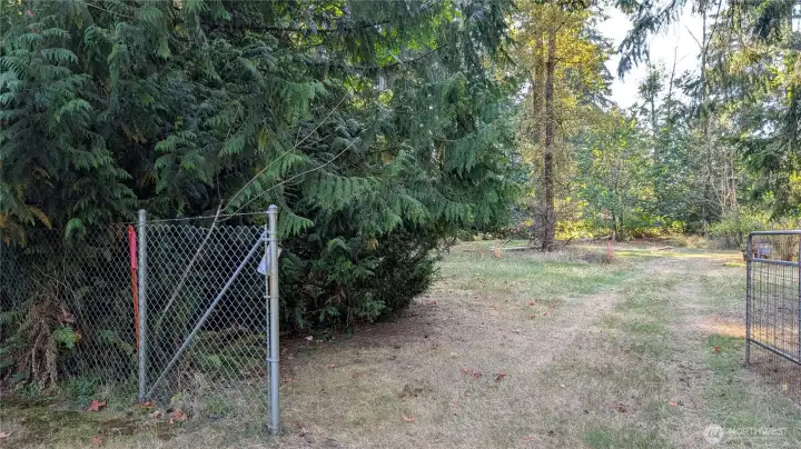 Easement. Flagged pole at the fence marks this properties NE corner w/the N. boundary line going towards the flagged pole in the distance.