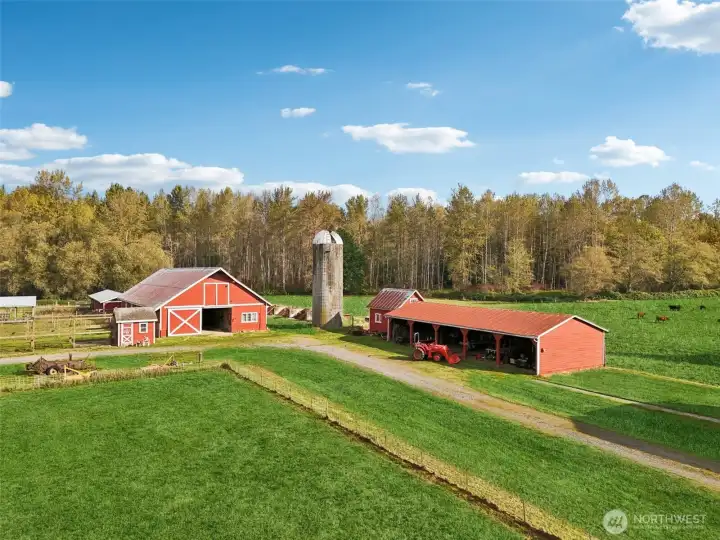 Multiple Outbuildings including 3500 sq ft Barn with Hay Loft, Tractor Shed, Cattle Feed Shed, Livestock enclosure and multiple Storage Rooms and Sheds!