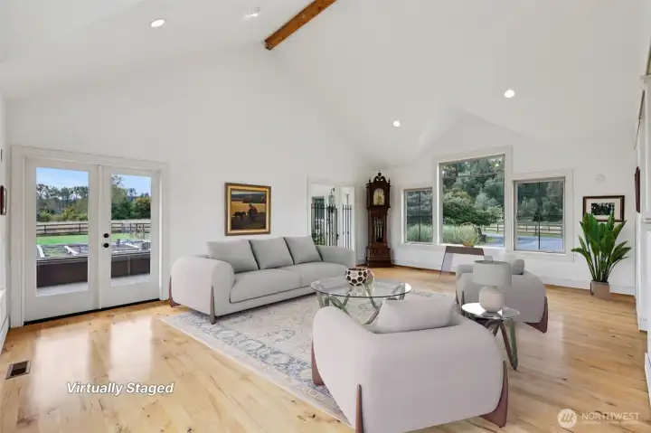 Living room with Soaring Ceilings and Beautiful Hardwood Floors....