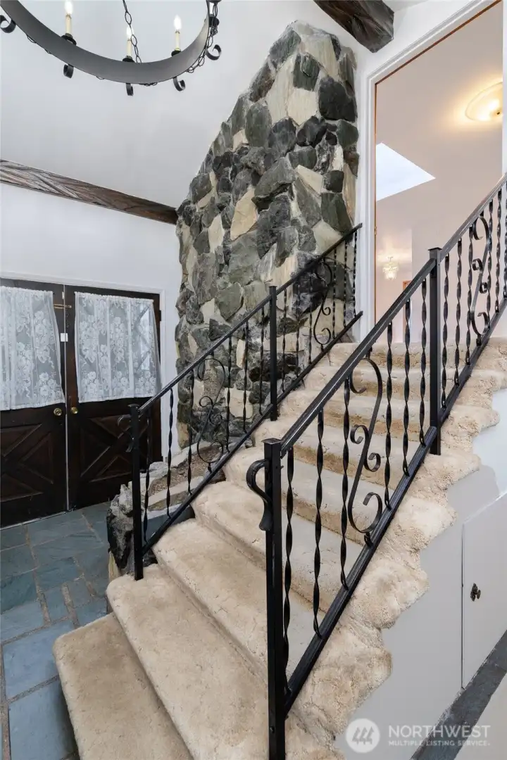 Step inside to grand foyer with vaulted ceilings and stone flooring.
