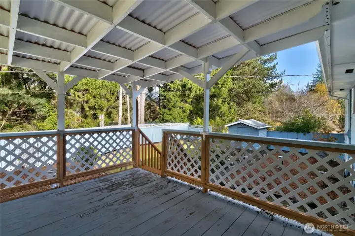 Covered deck off dining room has new railing and roof material.